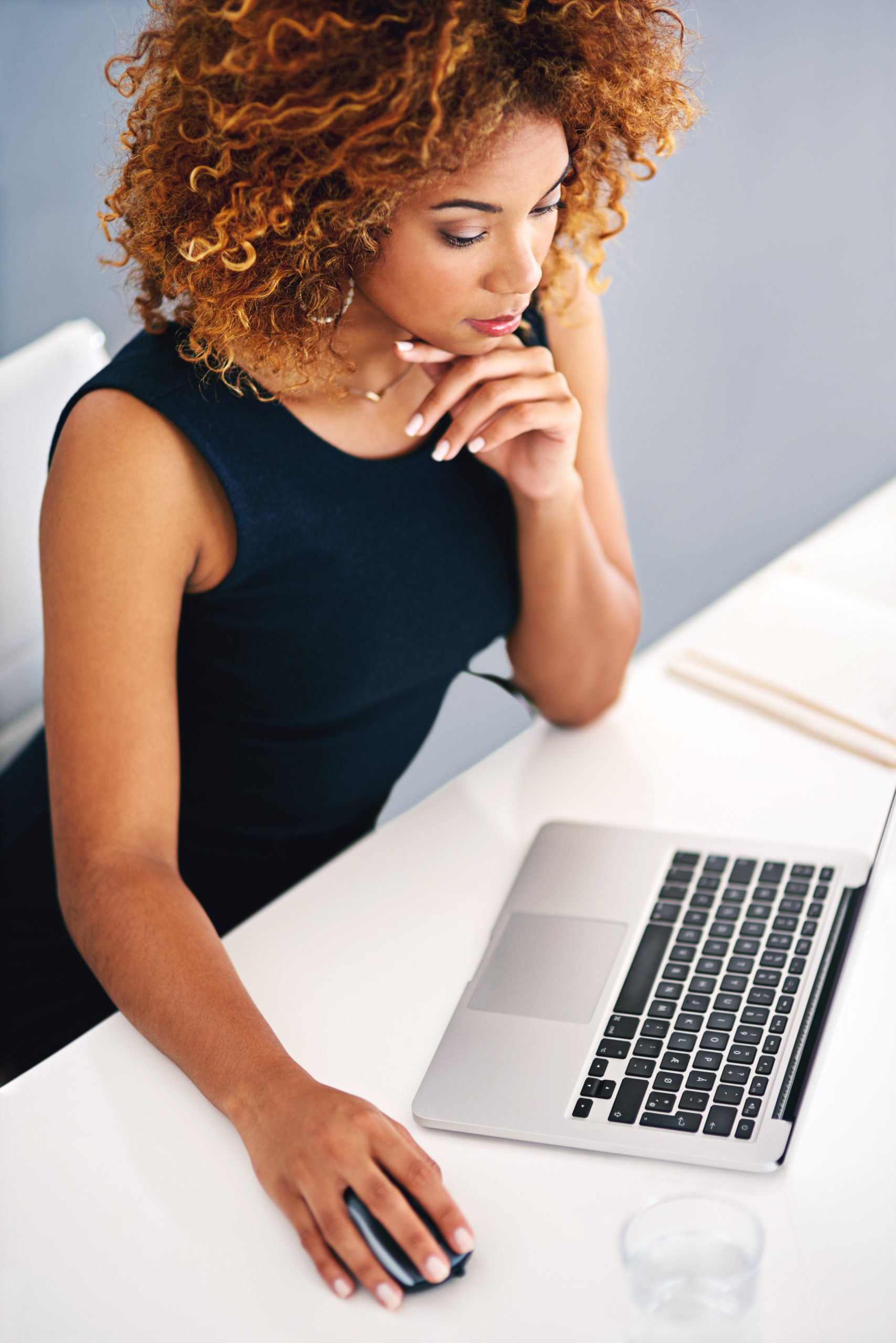 9.25.24_BlogImage Business, thinking and black woman with laptop, ideas and consultant with solution, choice and online reading. African person, worker or agent with decision, pc or connection for research or planning.